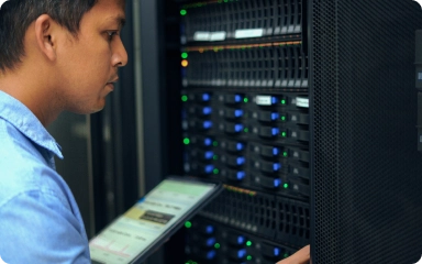 Man diagnosing server with a tablet in the server room